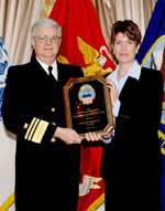 Karen Beagle, President of DARE Electronics, Inc. accepts award from Vice Admiral Lippert for Outstanding Readiness Support for a Woman-Owned Small Business
